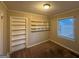 Cozy bedroom featuring built-in shelving, neutral paint, and plush carpeting at 1901 Clarke Ln, Decatur, GA 30035