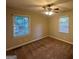 Inviting bedroom featuring plush carpet, neutral walls, and windows for natural light at 1901 Clarke Ln, Decatur, GA 30035