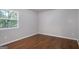 This is a bedroom with hardwood floors, a window, and neutral walls at 2894 Cushing Ct, Jonesboro, GA 30236