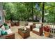 This staged deck features furniture and green scenery surrounding it at 2894 Cushing Ct, Jonesboro, GA 30236