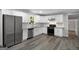 Modern kitchen featuring stainless steel appliances, granite countertops, and white cabinetry at 2894 Cushing Ct, Jonesboro, GA 30236