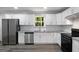 Modern kitchen featuring stainless steel appliances, granite countertops, and white cabinetry at 2894 Cushing Ct, Jonesboro, GA 30236