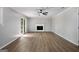 Bright living room has modern hardwood flooring, a fireplace and sliding glass door at 2894 Cushing Ct, Jonesboro, GA 30236