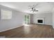 Spacious living room features modern hardwood flooring, fireplace, and ceiling fan at 2894 Cushing Ct, Jonesboro, GA 30236