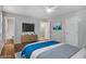 Light-filled main bedroom features a bed, dresser, ceiling fan, art and ample natural light at 2894 Cushing Ct, Jonesboro, GA 30236