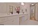 A bright bathroom featuring a double vanity with white cabinets and gold fixtures at 150 Butterton Ct, Fayetteville, GA 30214