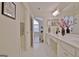 A bright bathroom featuring a double vanity, linen closet and tile floor at 150 Butterton Ct, Fayetteville, GA 30214
