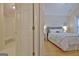 Primary bedroom featuring private bathroom, queen bed, and hardwood floors at 150 Butterton Ct, Fayetteville, GA 30214