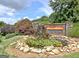 Stone entrance to The Villas at Gingercake with pond, water feature, and lush landscaping at 150 Butterton Ct, Fayetteville, GA 30214