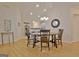 Dining room with hardwood floors, chandelier, and an adjacent kitchen area at 150 Butterton Ct, Fayetteville, GA 30214