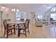 Open-concept dining room with hardwood floors and chandelier, flowing into the living area at 150 Butterton Ct, Fayetteville, GA 30214