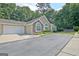 Charming home featuring a two-car garage, well-manicured landscaping, and a combination of siding and stone accents at 150 Butterton Ct, Fayetteville, GA 30214