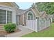 Close up exterior view of a home featuring stone accents, neat landscaping, and a white fence at 150 Butterton Ct, Fayetteville, GA 30214