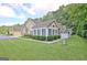 Charming exterior view of home with lush landscaping and a well-maintained lawn on a sunny day at 150 Butterton Ct, Fayetteville, GA 30214