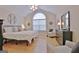 Spacious main bedroom with vaulted ceilings, arched window, and ample natural light at 150 Butterton Ct, Fayetteville, GA 30214