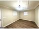 Simple bedroom featuring neutral walls, hardwood flooring, and natural light at 2159 Holly Hill Dr, Decatur, GA 30032