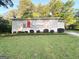 Charming single-story home with a red front door and well-manicured lawn and landscaping at 2159 Holly Hill Dr, Decatur, GA 30032