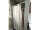 Compact bathroom featuring a shower with curtain, window and storage rack at 224 Potts Se Rd, Conyers, GA 30094