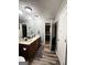 Well-lit bathroom with dual sinks, wood cabinets, and a mirror with vanity lights at 224 Potts Se Rd, Conyers, GA 30094