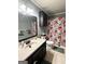 Cozy bathroom features a floral shower curtain and neutral-toned sink at 224 Potts Se Rd, Conyers, GA 30094