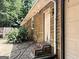 The home's side exterior showing a door and a brick stairwell, with blossoming plants nearby at 224 Potts Se Rd, Conyers, GA 30094