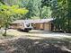 Exterior view featuring a well-maintained lawn, RV parking, and the rustic charm of the house at 224 Potts Se Rd, Conyers, GA 30094