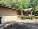 The exterior showcases a large garage door complementing the cozy front porch of the rustic home at 224 Potts Se Rd, Conyers, GA 30094