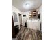 Efficient laundry room with washer, dryer, and wooden shelving unit at 224 Potts Se Rd, Conyers, GA 30094