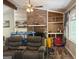Comfortable living room showcasing a brick fireplace, built-in shelving, and stained glass window at 224 Potts Se Rd, Conyers, GA 30094