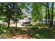 Spacious landscaped backyard with mature trees and a screened in porch at 3308 Quail Sw Run, Marietta, GA 30008