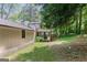 Wide shot of a large lot with mature trees and a screened in porch at the rear of the home at 3308 Quail Sw Run, Marietta, GA 30008