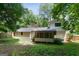 Landscaped backyard features a screened porch and mature trees offering plenty of privacy at 3308 Quail Sw Run, Marietta, GA 30008