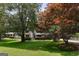 Home featuring a manicured lawn and mature trees in a lush landscape at 3308 Quail Sw Run, Marietta, GA 30008