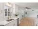 Updated kitchen offers stainless steel appliances, quartz counters, and views into the living room at 3308 Quail Sw Run, Marietta, GA 30008