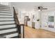 White-cabinet kitchen with stainless steel appliances and hardwood floors, viewed from the staircase at 3308 Quail Sw Run, Marietta, GA 30008