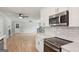 Bright kitchen with stainless appliances, quartz countertops, and views into the living room with fireplace at 3308 Quail Sw Run, Marietta, GA 30008