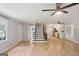 Spacious living room with hardwood floors, ceiling fan, and staircase leading to the upper level at 3308 Quail Sw Run, Marietta, GA 30008