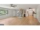 Living room with staircase leading to the upper level and white-cabinet kitchen visible in the background at 3308 Quail Sw Run, Marietta, GA 30008
