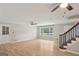 Large open-concept living room with hardwood floors, neutral walls, staircase, and ceiling fans at 3308 Quail Sw Run, Marietta, GA 30008