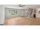 Bright living room with hardwood floors, staircase, large window, and neutral paint tones at 3308 Quail Sw Run, Marietta, GA 30008