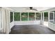 Screened porch with wooden flooring, white trim, curtains and views of the wooded backyard at 3308 Quail Sw Run, Marietta, GA 30008