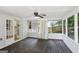 Screened porch with white trim, black ceiling fan, and views of a wooded backyard at 3308 Quail Sw Run, Marietta, GA 30008