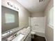 Bathroom with granite counter, a tub-shower combo and wood-look floors at 5405 Lakeside Dr, Union City, GA 30291