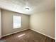 Bedroom with plush carpeting, a window, and textured ceilings at 5405 Lakeside Dr, Union City, GA 30291