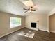 The sunlit living room features a stone fireplace, wood floors, and a ceiling fan at 5405 Lakeside Dr, Union City, GA 30291
