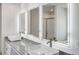 Modern bathroom with sleek, illuminated mirrors, granite countertops, and vessel sinks for a luxurious, contemporary feel at 1672 Fuma Leaf Way Rd, Mcdonough, GA 30253