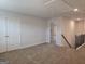Upstairs hallway featuring neutral walls, plush carpet, and white doors, offering a bright and inviting transition space at 1672 Fuma Leaf Way Rd, Mcdonough, GA 30253