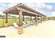 Inviting pergola with lounge chairs by the community pool, offering shade and relaxation for residents at 1672 Fuma Leaf Way Rd, Mcdonough, GA 30253