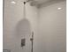 Modern shower with white subway tile, showcasing a rainfall shower head and sleek fixtures for a spa-like experience at 1672 Fuma Leaf Way Rd, Mcdonough, GA 30253