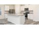 Modern kitchen features stainless steel appliances, white cabinets, and a large island with granite countertops at 307 Limestone Circle, Conyers, GA 30013